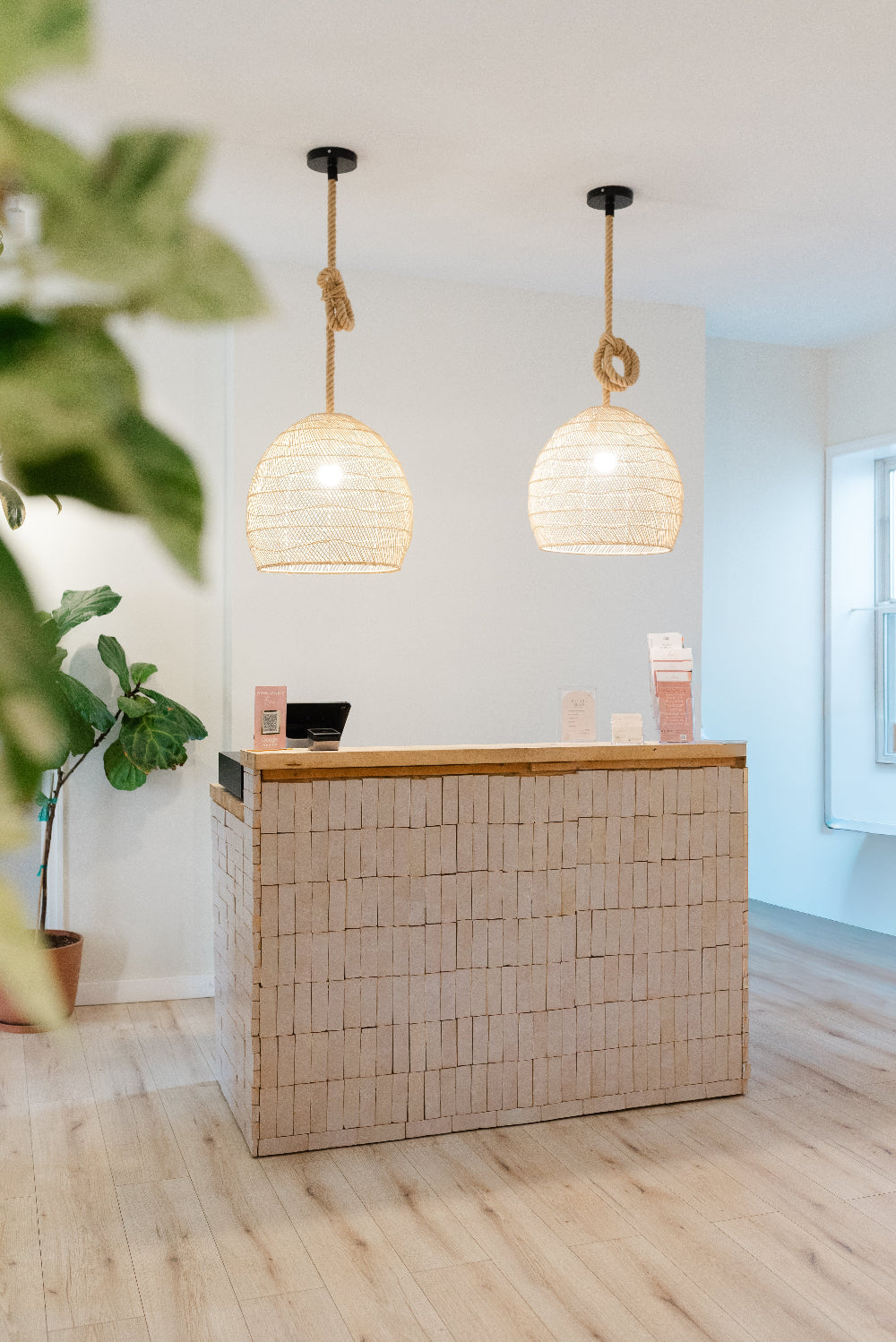 Modern interior with a reception desk and decorative lights.