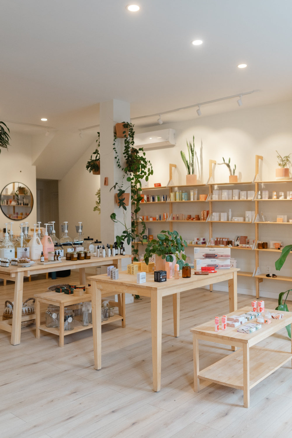 Modern interior with wooden tables and shelves in a light-colored room.